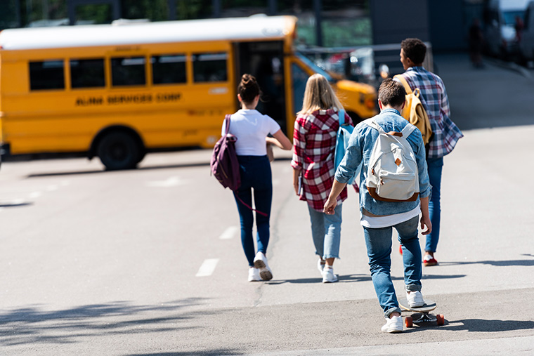 Children walking toward school bus