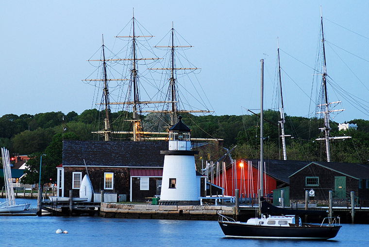 Mystic Seaport Lighthouse with tall ships.
