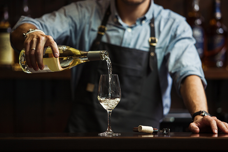 Man pouring a glass of white wine